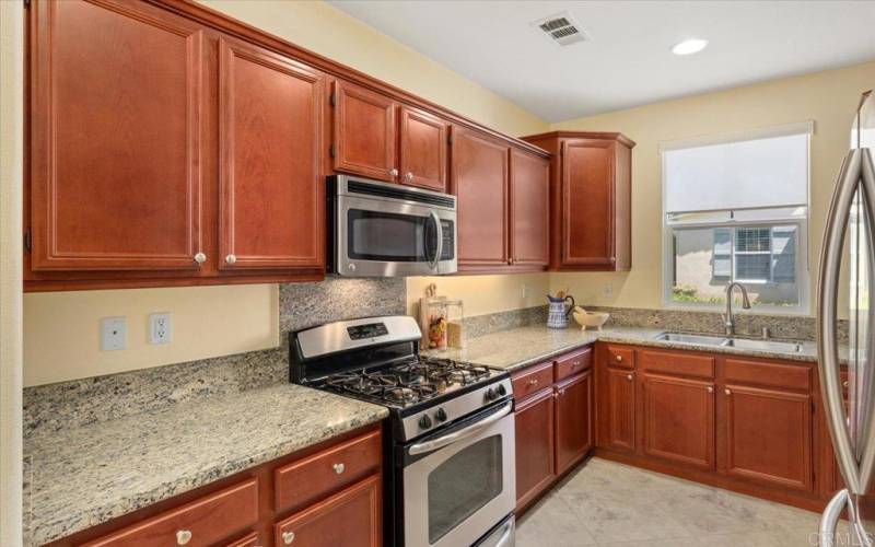 Kitchen with new stainless sink and stainless appliances that all convey