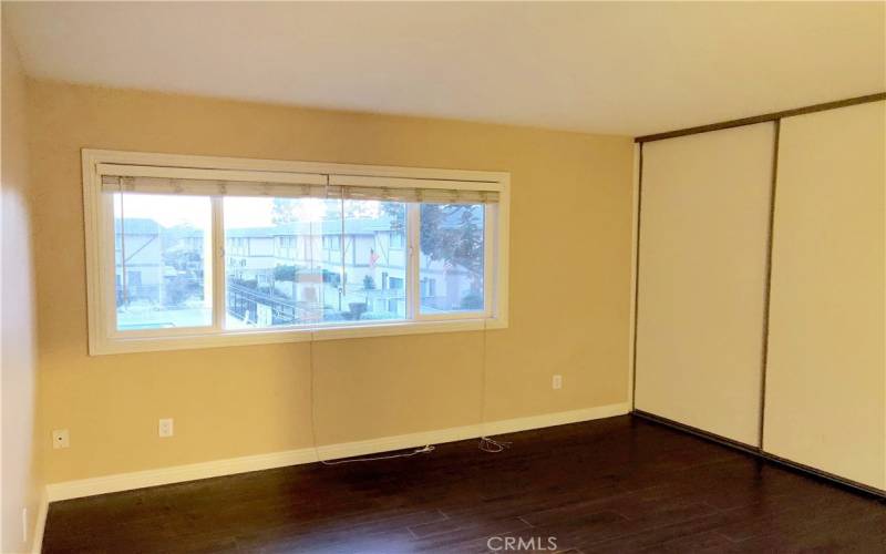 Spacious Bedroom with Large Closet and View of Community Pool