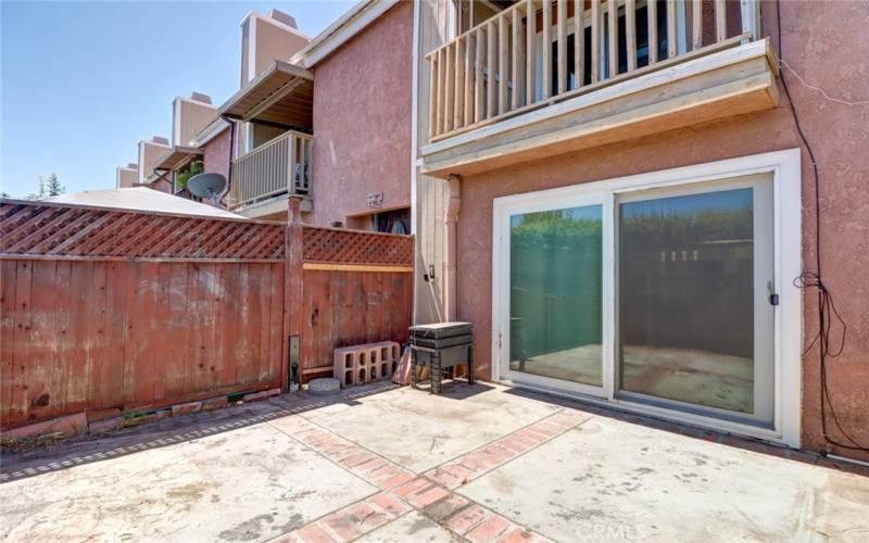 Front patio, primary bedroom above Sliding Door