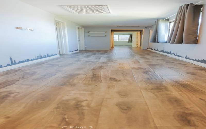 Hallway view, shared bath, Bedroom 2, and Bedroom 3 at the end.