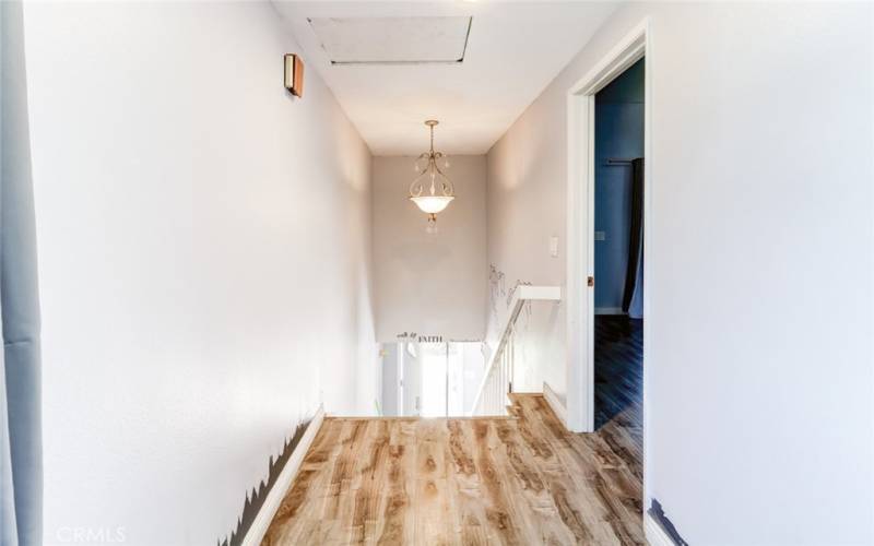 Upstairs hallway, primary bedroom entrance.