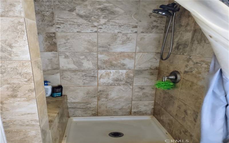 travertine shower with bench