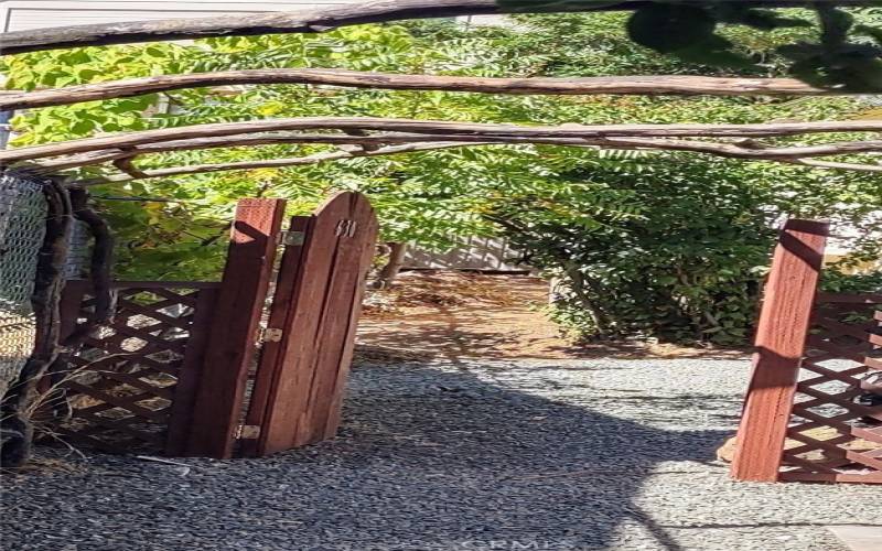 side yard w/ arbor leads to 630 Sixth St. Serenity Cottage