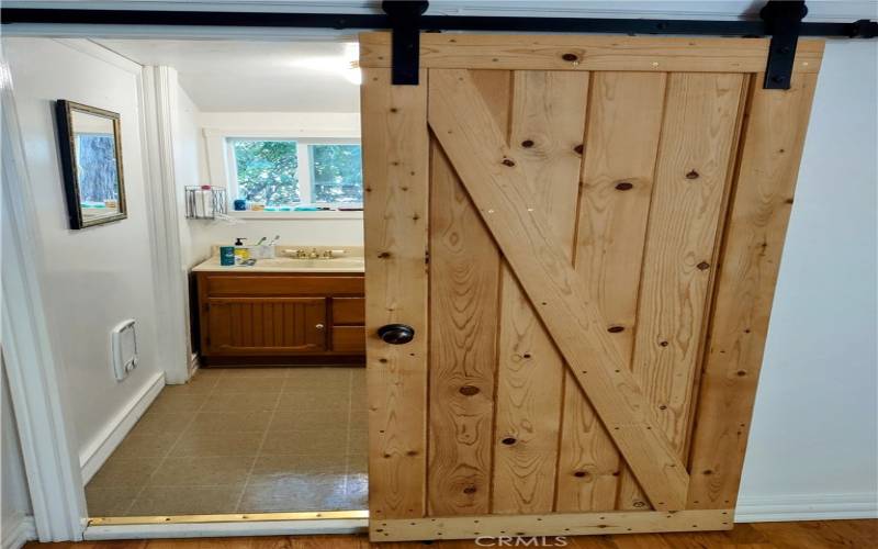 knotty pine barn door to bath