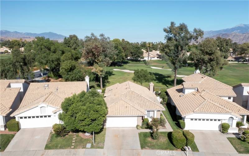 aerial view showing golf course behind