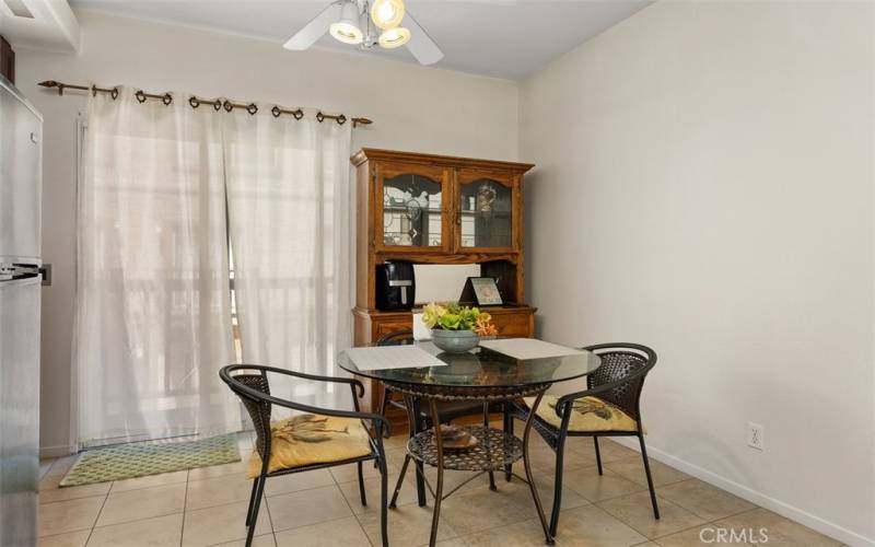 Dining area with ceiling fan. Outdoor balcony