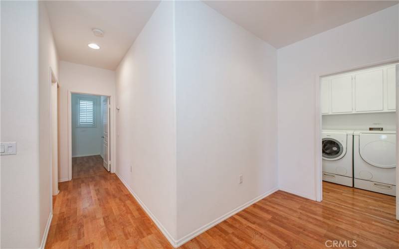 Hall with linen closet leading to the back guest bedroom and full guest bath.