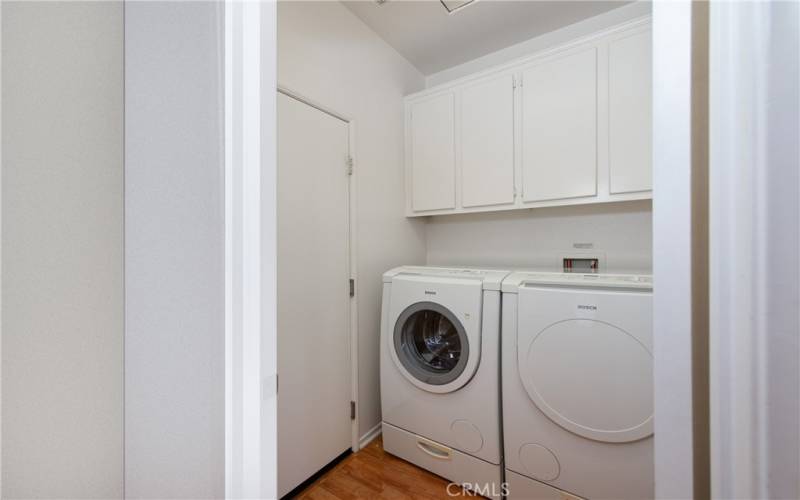 Laundry room with cabinets.