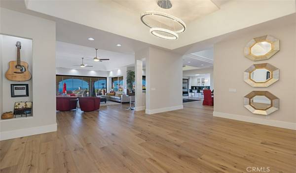 Entry foyer with gorgeous wood flooring and fabulous light fixures.