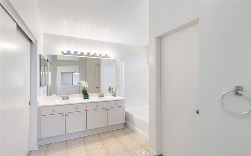 Spa-like master bath with double sinks and chic lighting