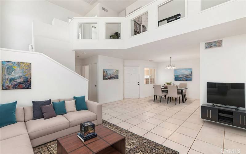 Bright living area and a staircase with a overview of the family room