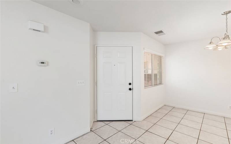 Front door entry with tile floors and simple lighting