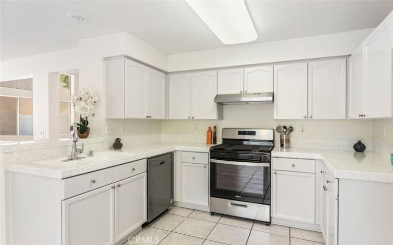 Clean and bright kitchen with white cabinetry and modern appliances