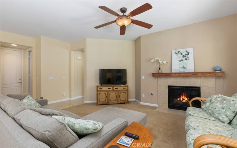 Fireplace with mantle and entertainment area