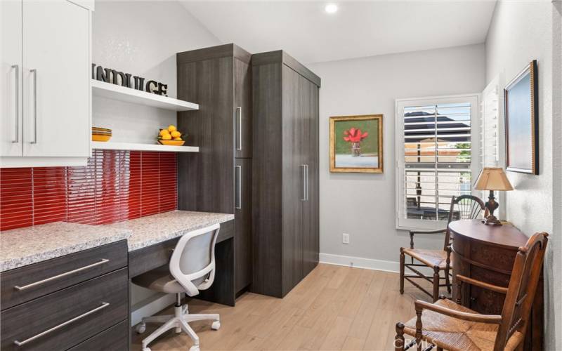 Next to the desk area there is a pull out pantry and in the corner is the stackable laundry closet.