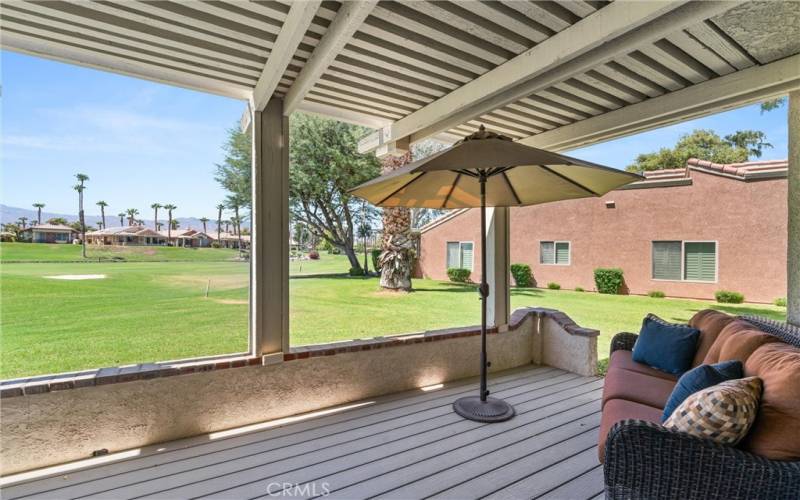 Covered patio with golf view.