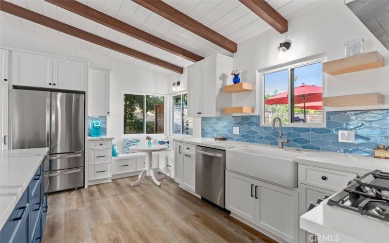 Kitchen with seating next to coffee station.