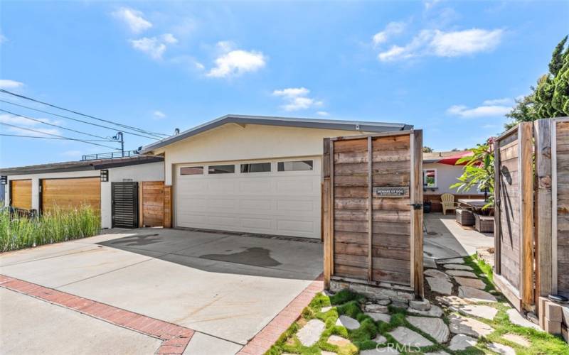 Very large private courtyard with a table for 12, and a bubbling hot tub.  Driveway large enough for two cars and a golf cart.