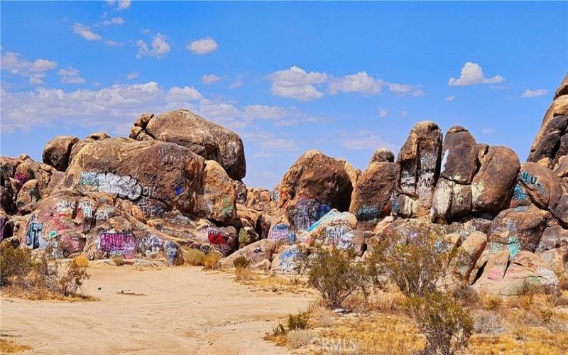 Graffiti rocks are not the subject property. This view is alongside paved Old Woman Springs Rd. on the way to the property.