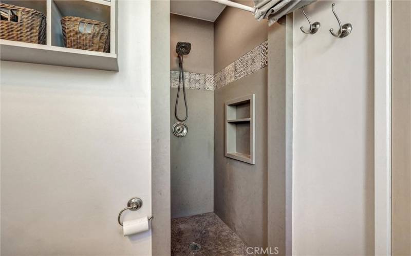 Caesarstone walls in primary shower, with built in shampoo shelf