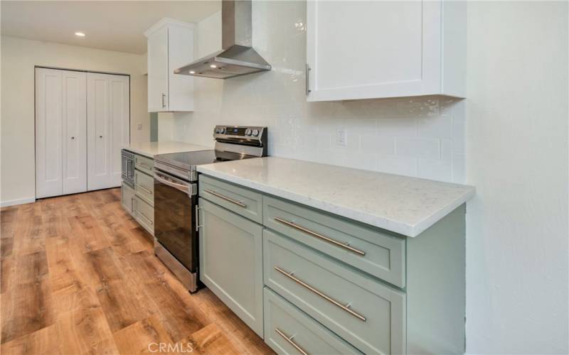 Custom cabinetry with pull out shelving, stainless hood & more