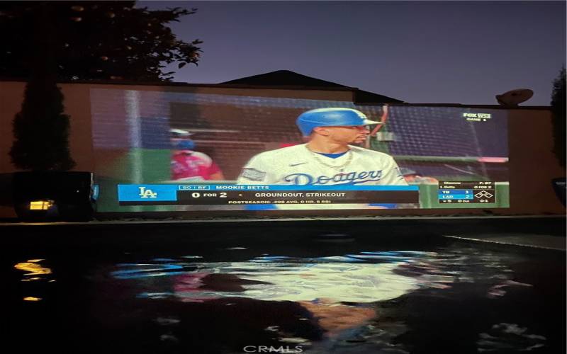 The owners projector shows on the pool wall. Imagine pool party movie nights here this summer!