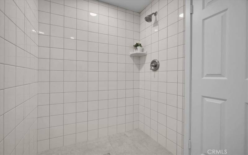 Primary shower is fully tiled at floor and in shower stall