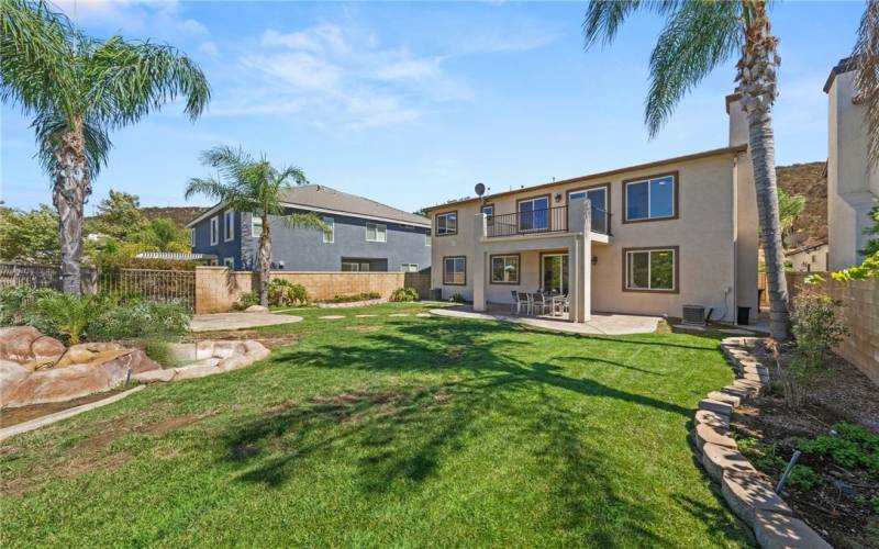 View of backyard- large grassy area with plenty of space for a pool if desired