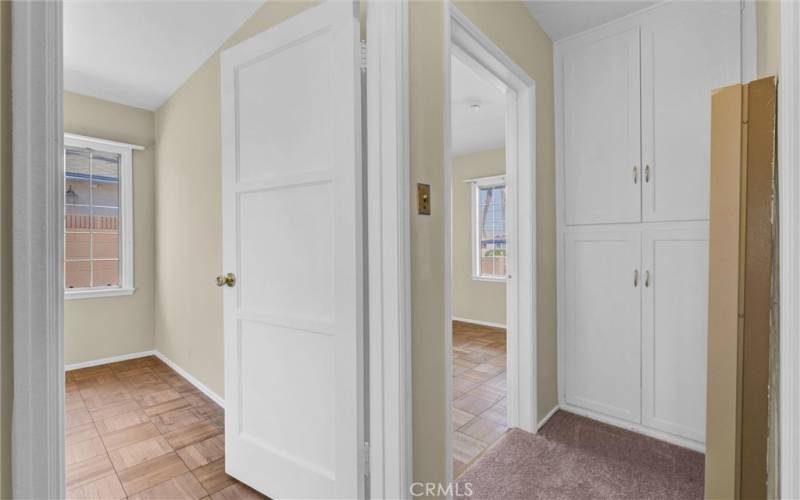 Hallway freshly painted with new carpet and plenty of linen space in hall.