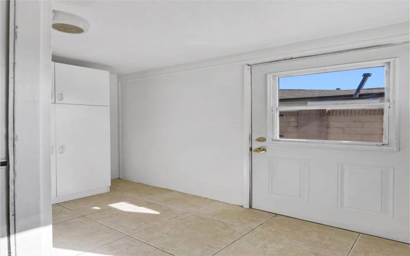 More storage space next to kitchen, side entrance from backyard.