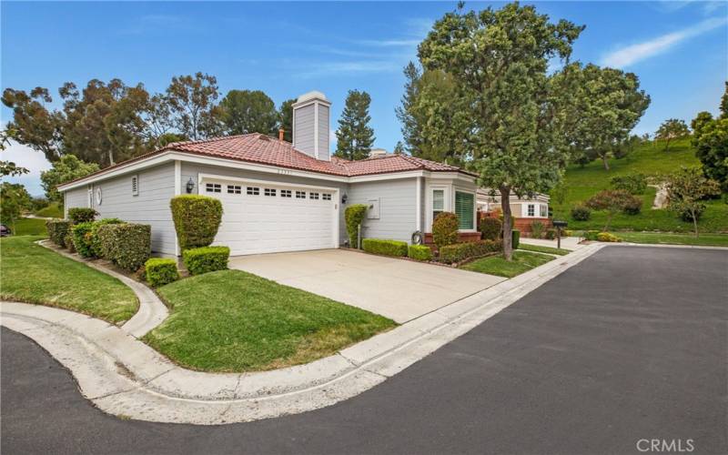 Front of the home with a side green belt leading to the massive green belt in the back