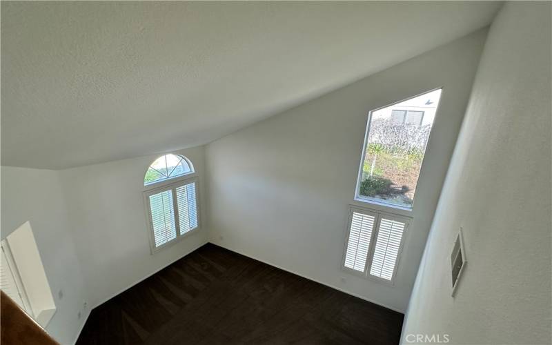 Looking down upon the living room from second story hallway...