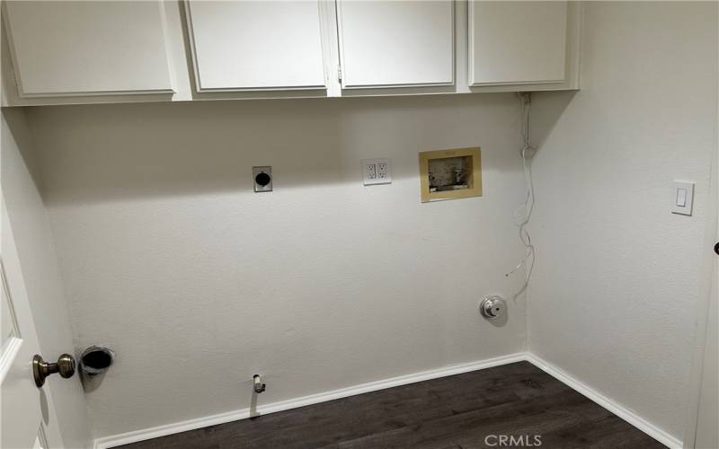 Inside laundry room with direct access to garage and front hall.