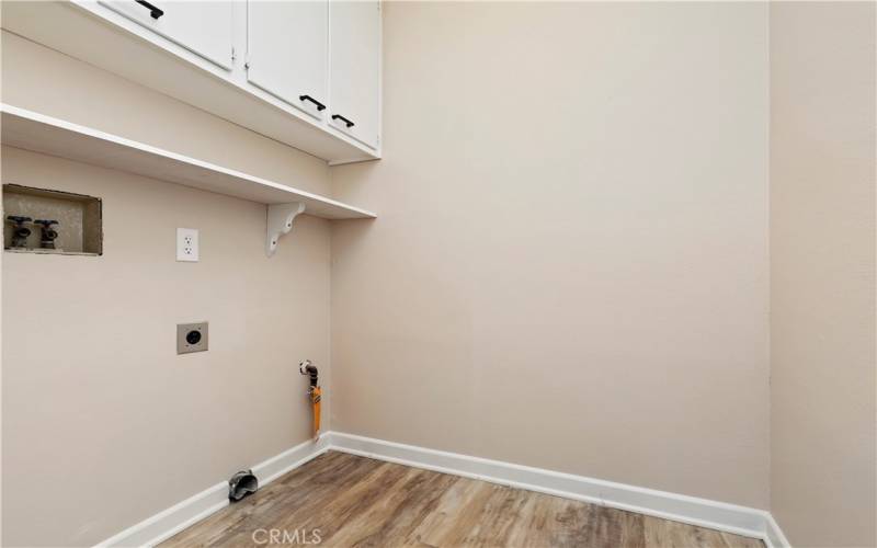 Laundry Room located between garage door access and the kitchen