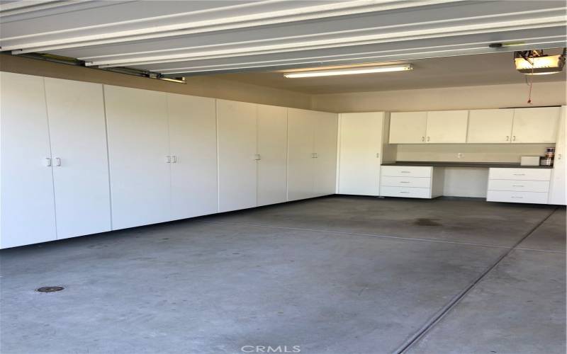 3 Car Garage with Built - in Cabinets