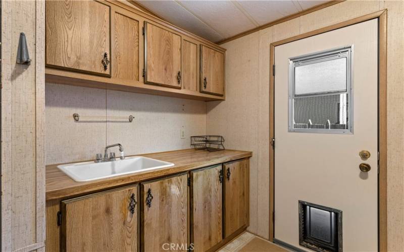 Laundry Room with storage and deep sink.