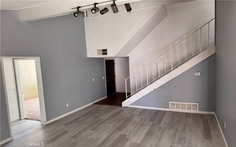 Vaulted ceilings in living room and wood flooring