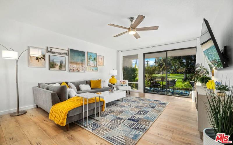 Living room opens to the golf course and mountain view