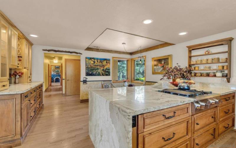 View from kitchen to entry, custom cabinetry, and reclaimed barnwood ceiling trim.