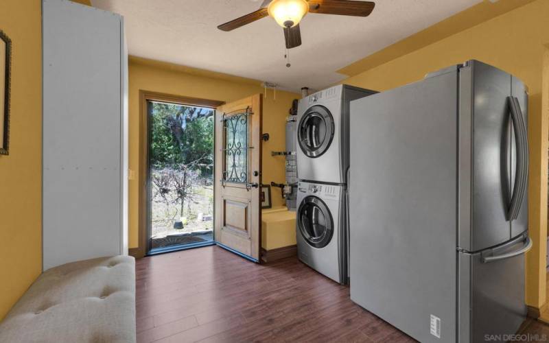 Spacious Laundry-mudroom door features a full-size screen and attractive opening window set in the door.