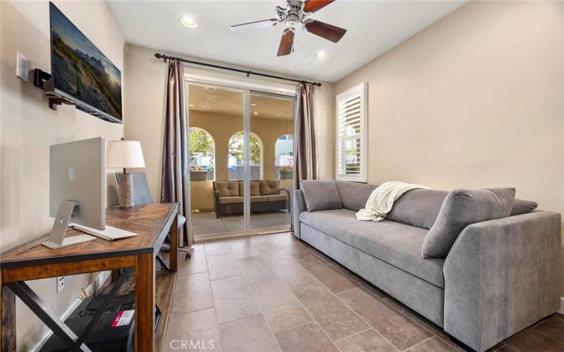 MAIN FLOOR BEDROOM WITH CLOSET AND SLIDING DOOR TO COVERED PATIO