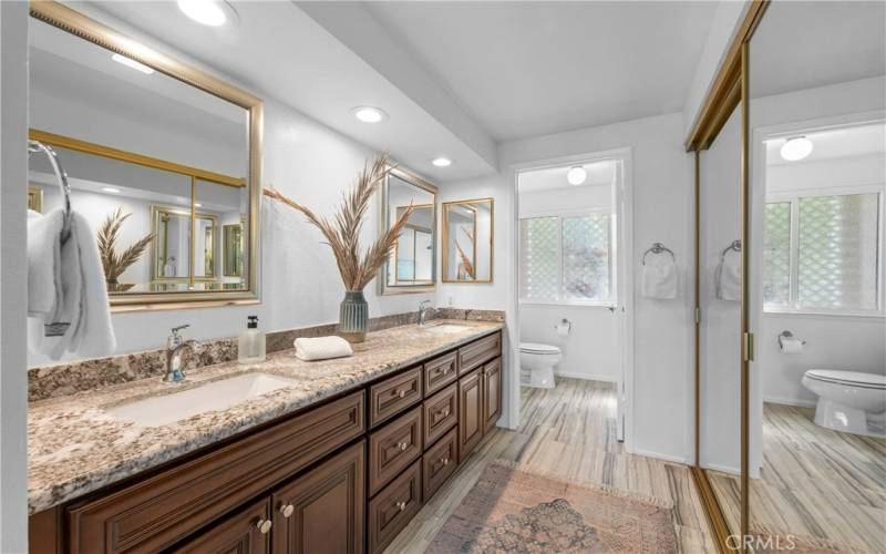 Primary En Suite Bathroom with Mirrored Closets and dressing area