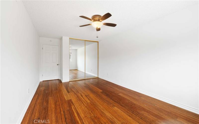 This Bedroom offers bamboo flooring, mirrored closet & Ceiling fan light fixture