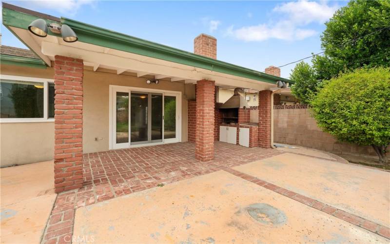 Covered brick patio perfect for barbecue & fun.