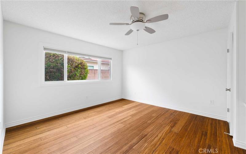 Plenty of space in the bright room with ceiling fan light, bamboo floorsand dual paned window