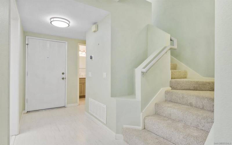 Formal entry and powder bathroom to right of front door