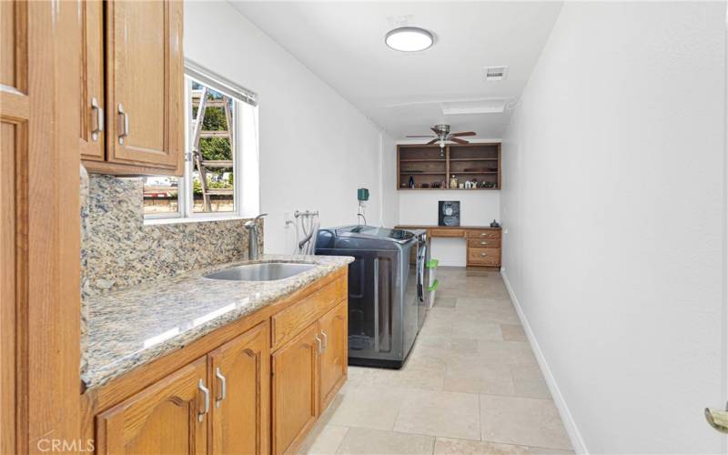 Massive laundry room with sink, storage and desk area