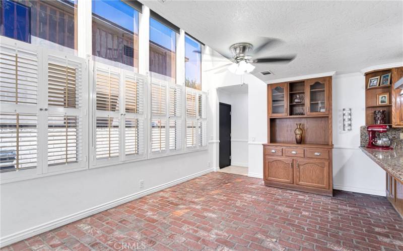 Kitchen Nook area with brick flooring and a wall of windows!