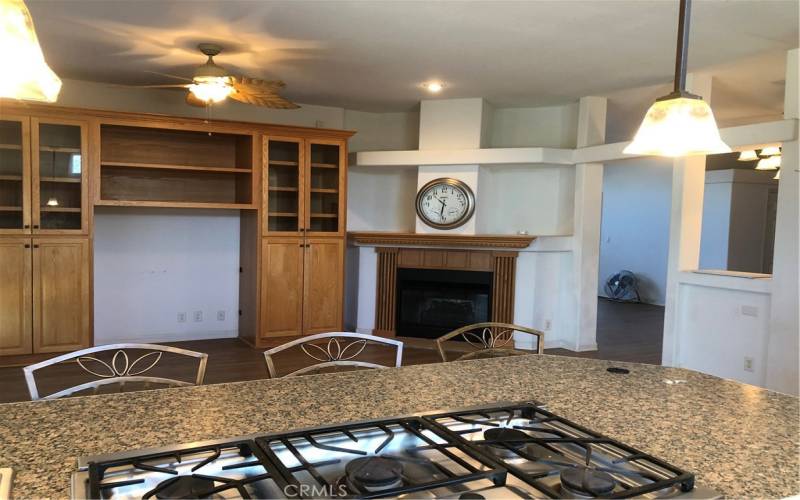 Kitchen island with bar seating and 5-burner propane cooktop, is open to family room.