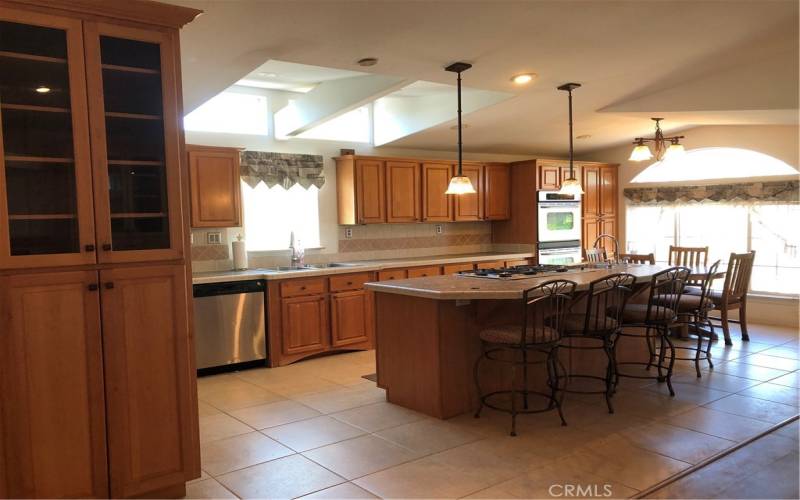 Kitchen with bar seating and breakfast area.